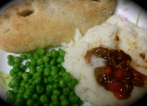 Cornish pasty with mashed potatoes and peas